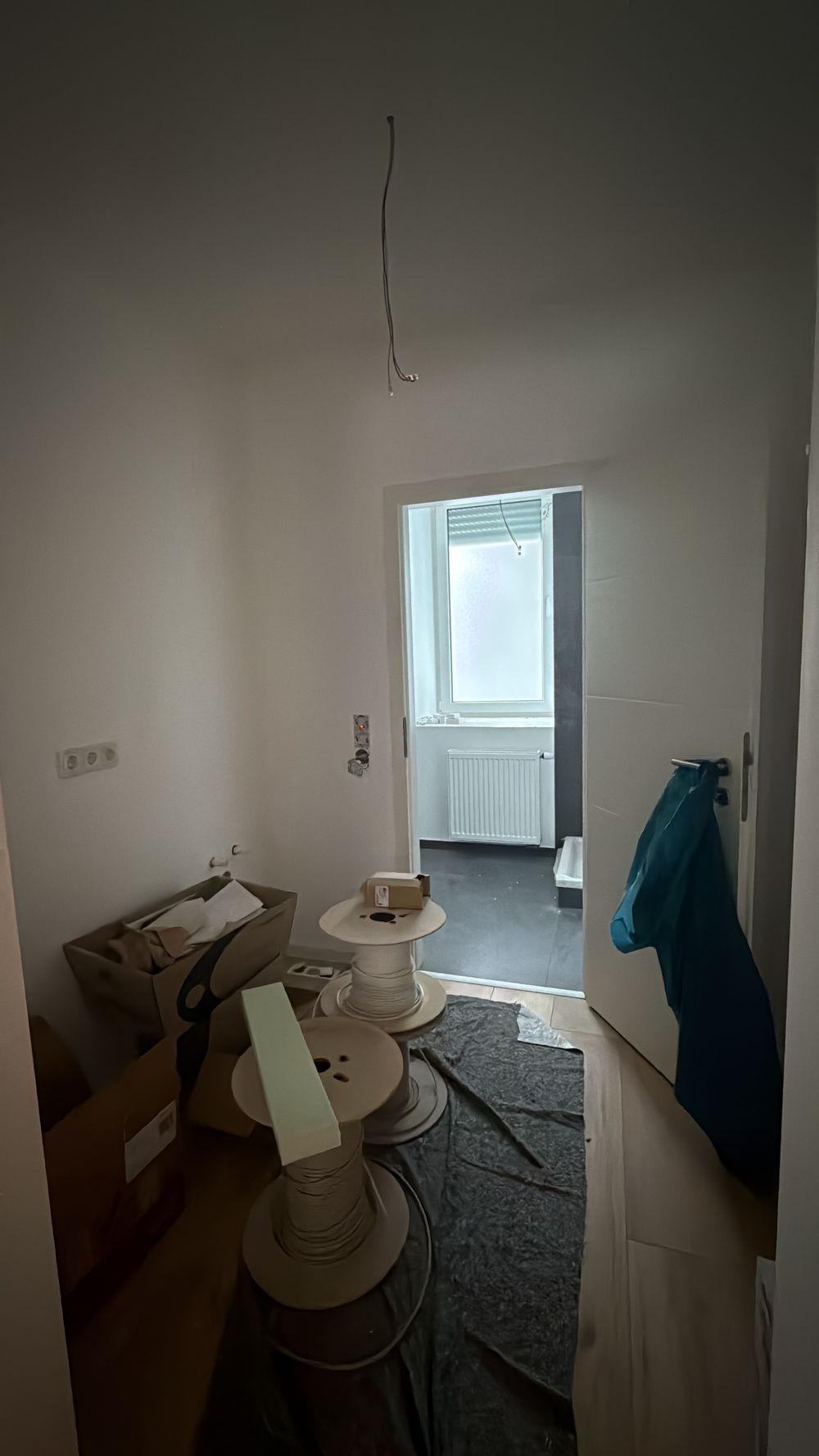 Flur der Wohnung während der Bauarbeiten mit Blick durch die Tür in das Badezimmer
